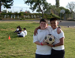 Students holding soccer ball 